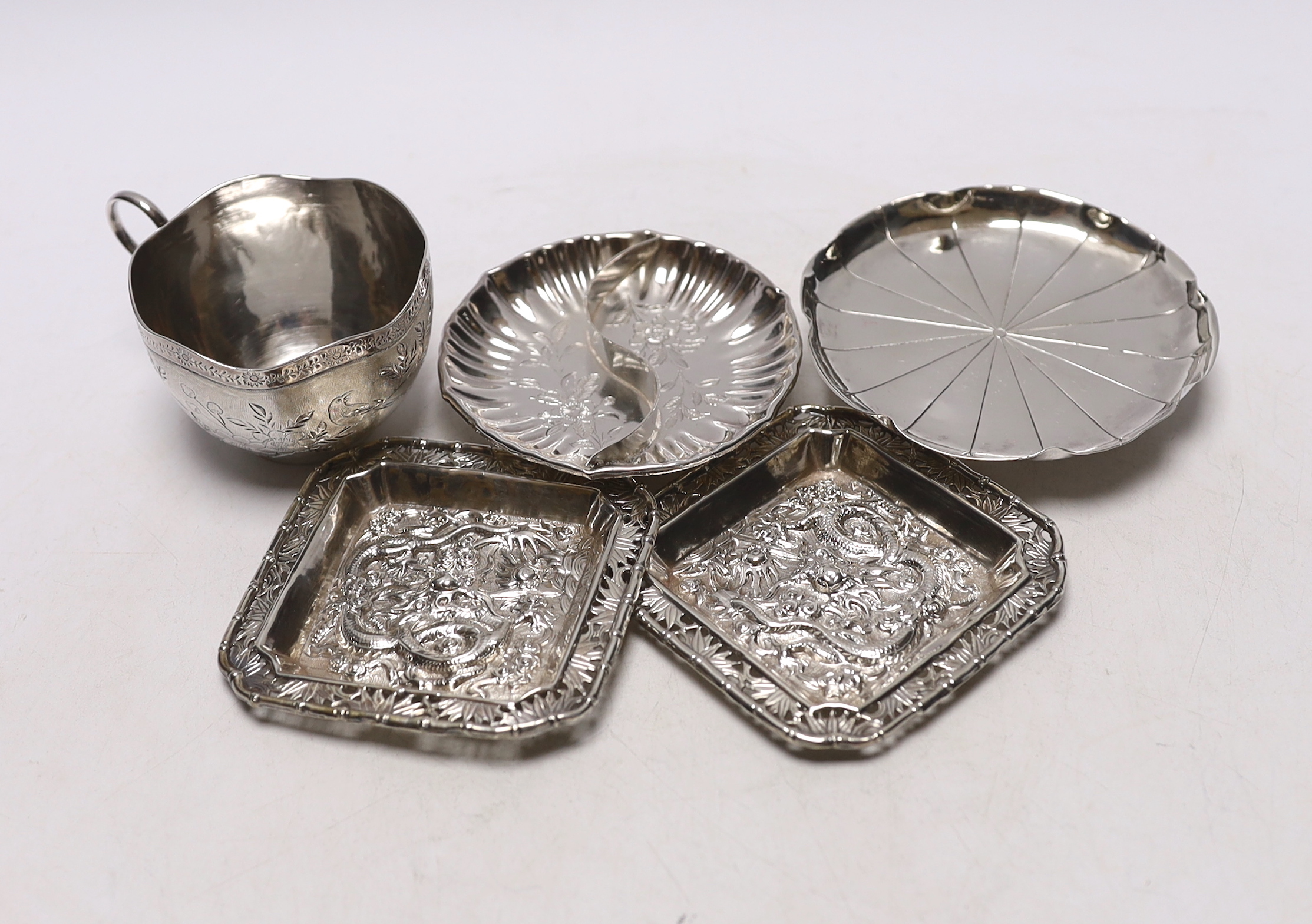 Chinese white metal items including two shaped dishes, a tea cup and two dragon dishes, largest 10.2cm, 8.2oz.